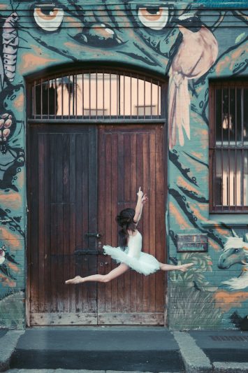 woman dancing in front of a wooden door