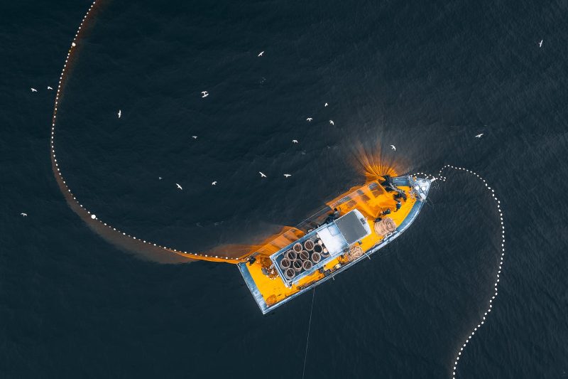 drone view of fishing trawler on sea