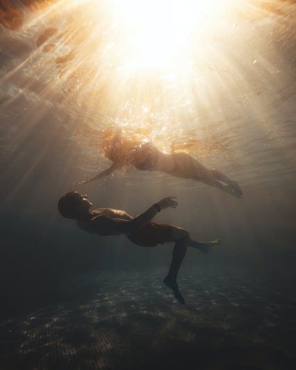 sunlight over couple diving