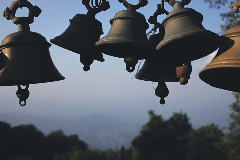 photography of black hanging bells during daytime