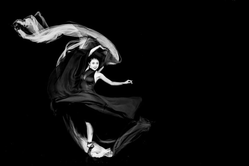 monochrome photo of a dancing woman in black dress