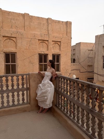 the bride standing in the corner of a balcony