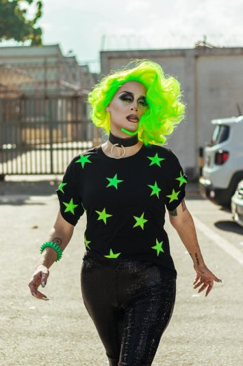 woman wearing black and green star print shirt