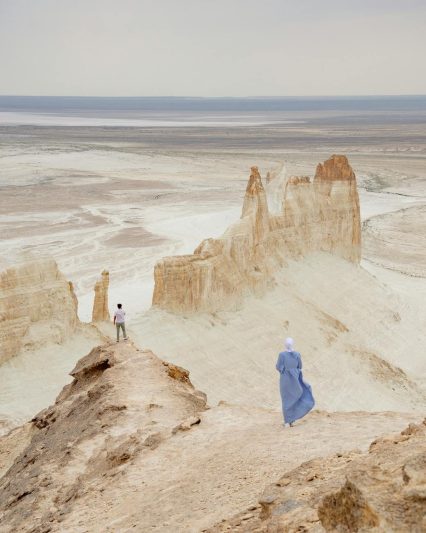 man and woman in desert of ustyurt plateau