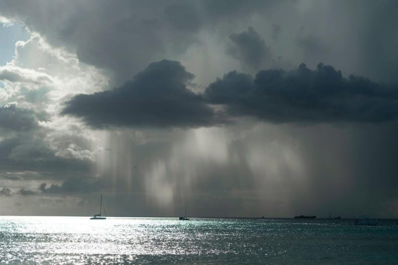 a boat is seen in the ocean under a dark cloud