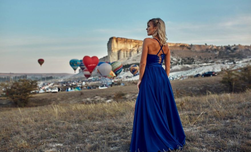 a woman wearing a blue dress outdoors