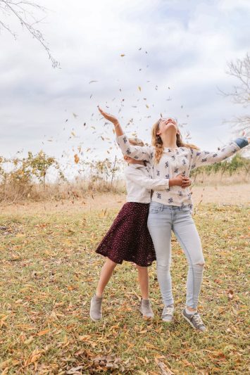 cheerful girls throwing confetti