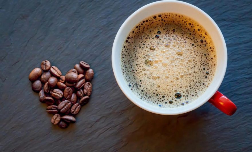 heart shaped coffee beans with fresh brew