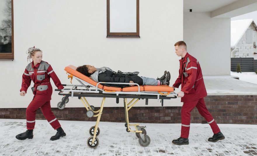 paramedics pushing woman on a stretcher