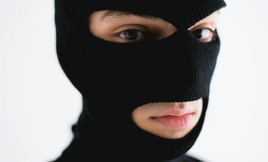 close up shot of a person wearing a robber mask