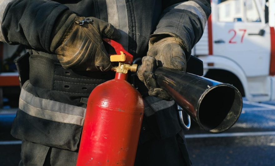 firefighter holding fire extinguisher