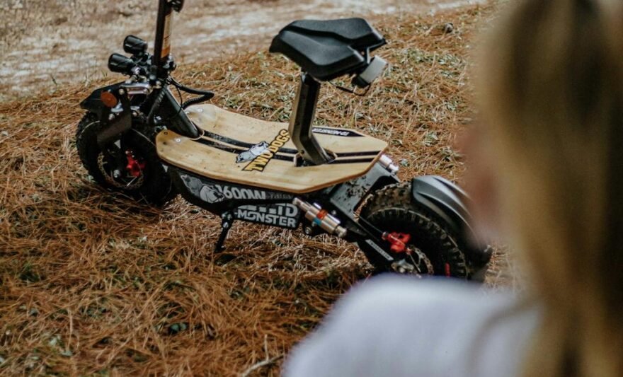 photograph of a scooter on dry grass