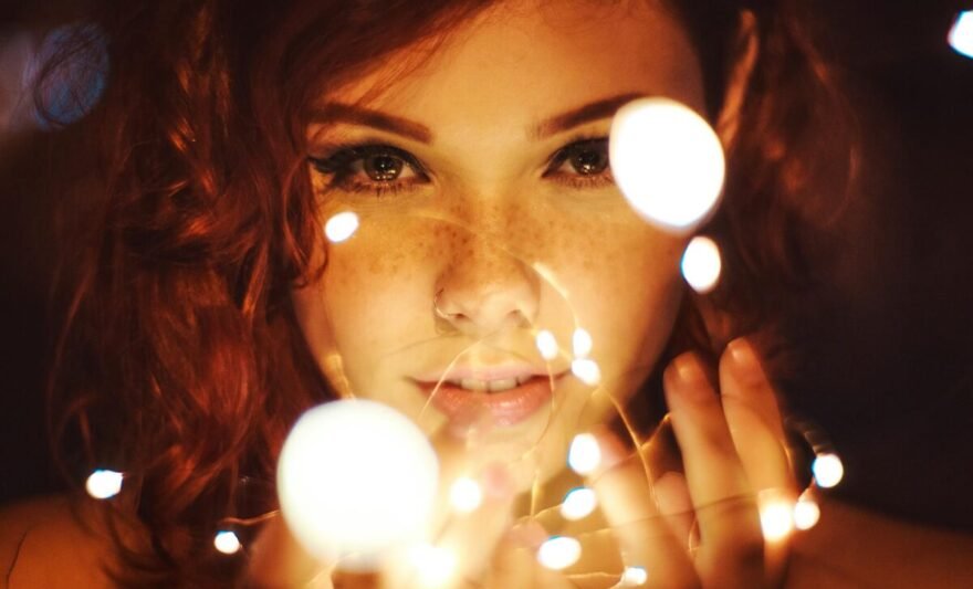 photography of a woman holding lights