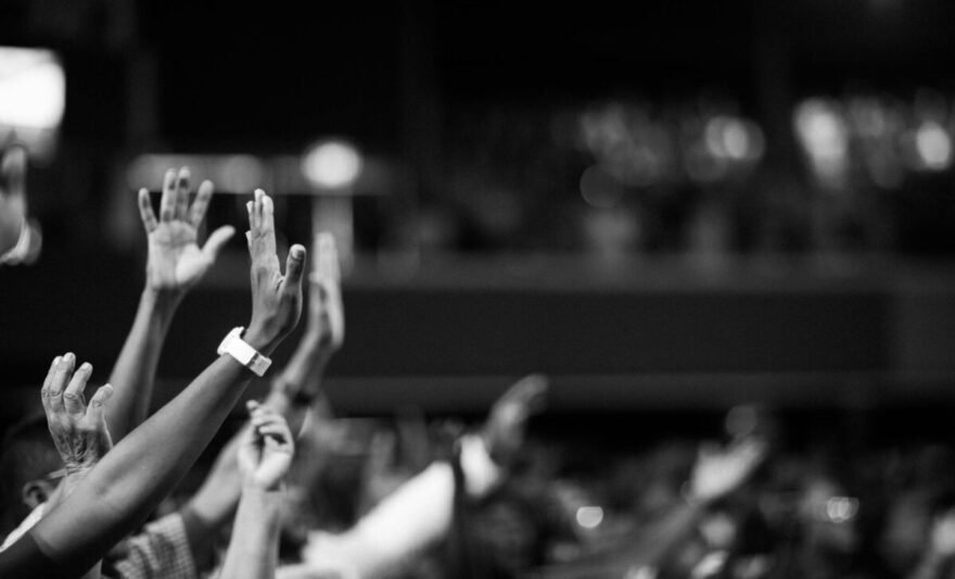 grayscale photography of hands waving