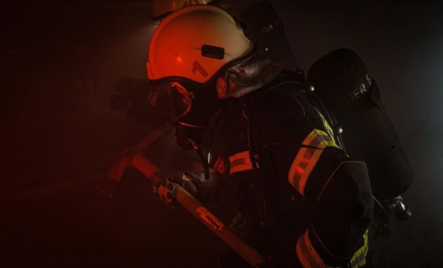 photograph of a firefighter holding an axe