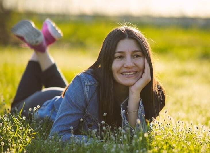 young woman relaxing in sunny meadow