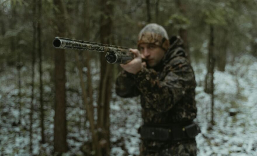 photo of a man aiming a shotgun