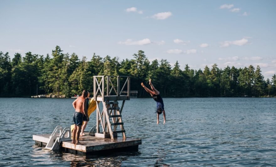 people jumping into lake