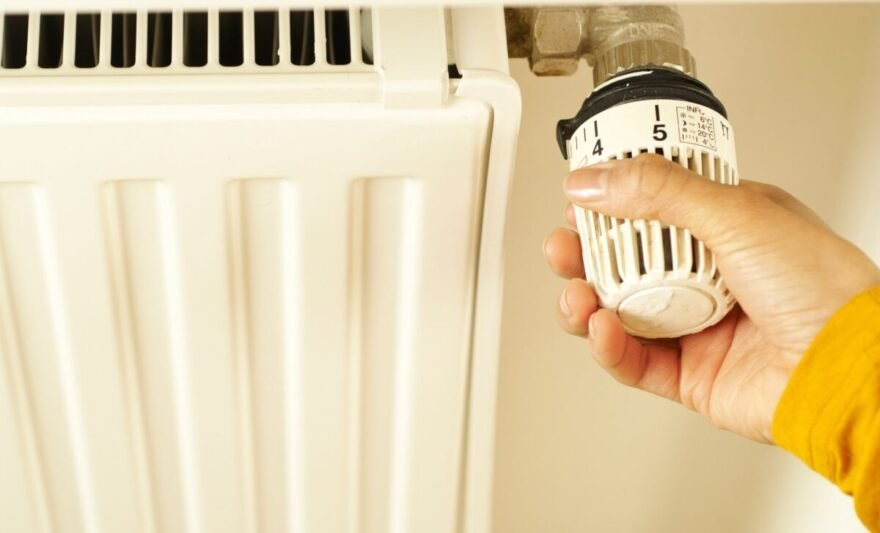 hand of a person turning the radiator valve