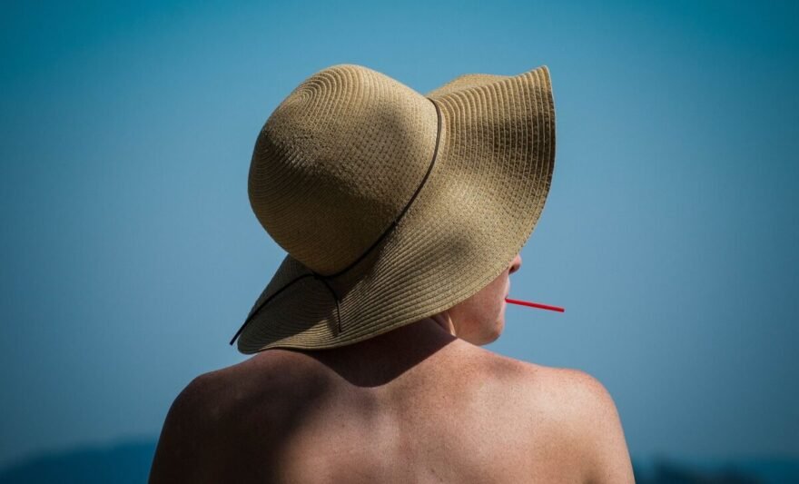 woman relaxing at beach with sun hat