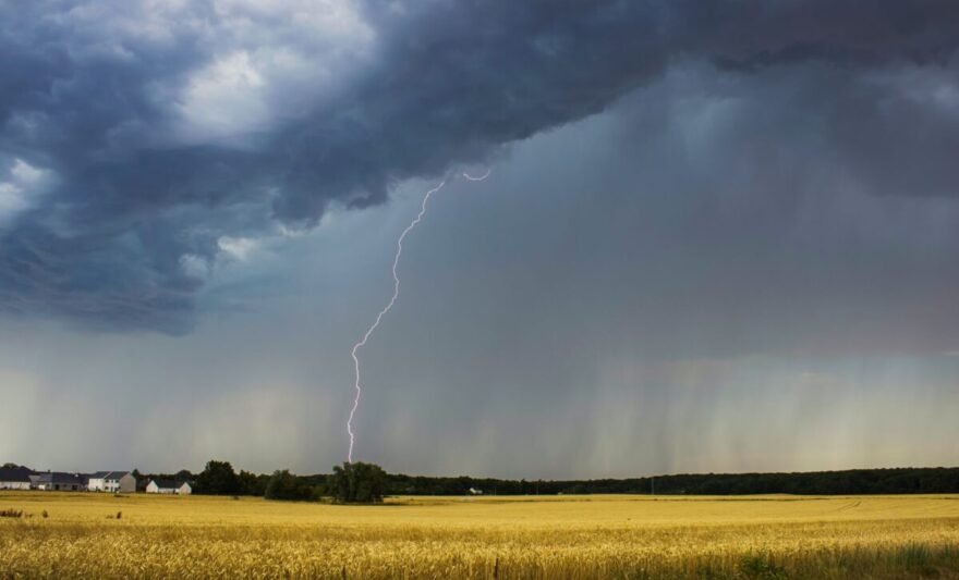 dramatic thunderstorm over farmland landscape