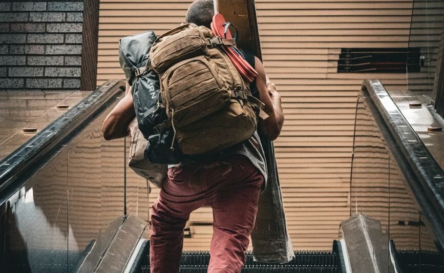 a person walking up an escalator