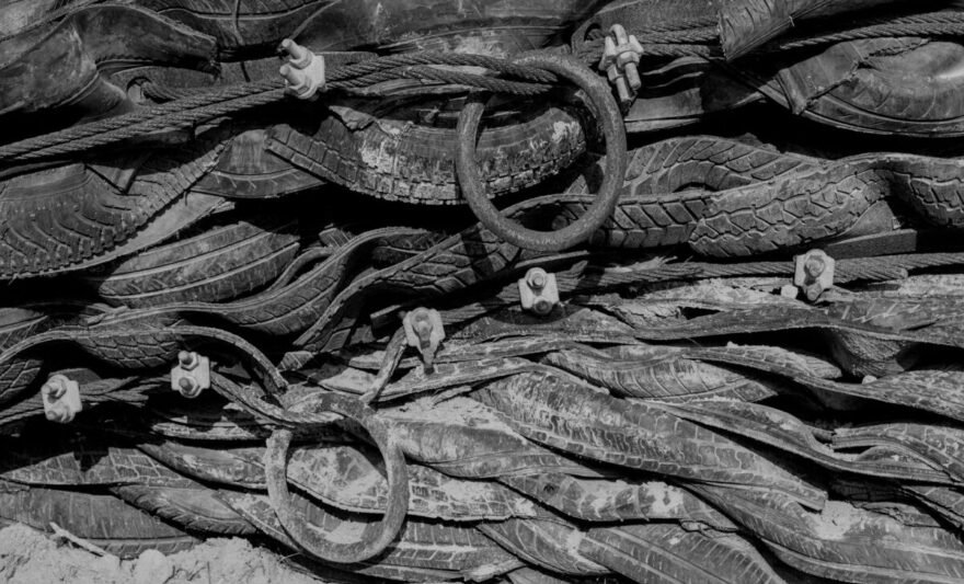black and white photograph of a pile of shoes