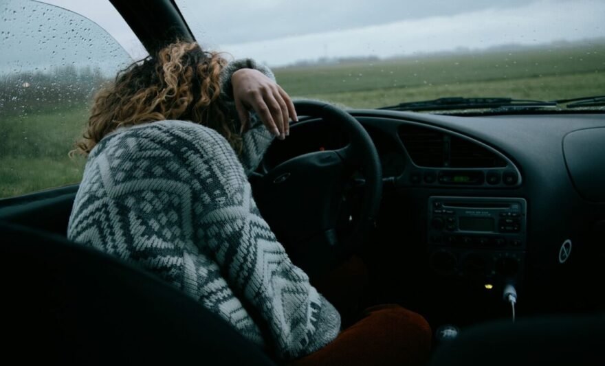 unrecognizable woman sitting in car